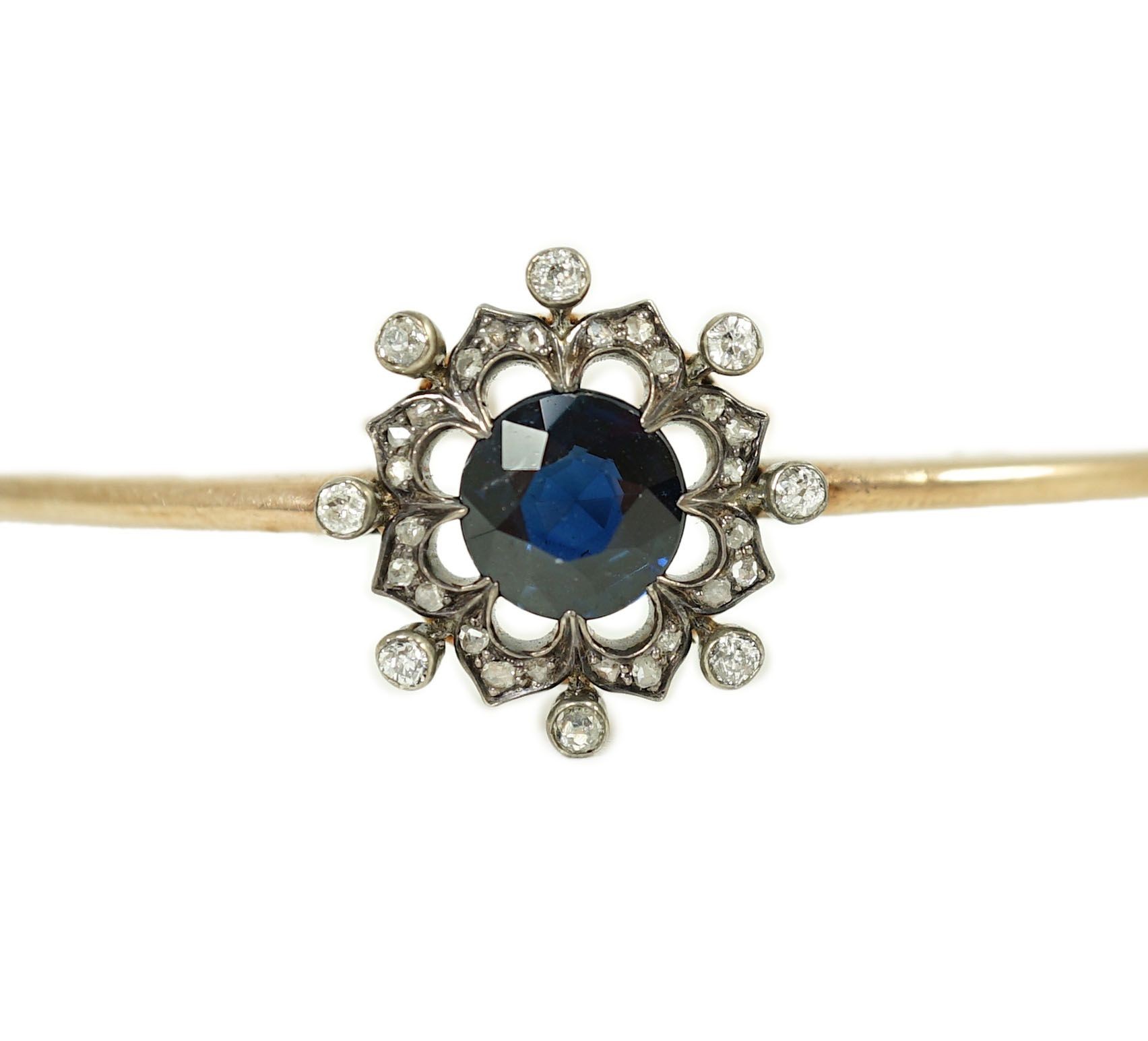 A Victorian gold, sapphire and diamond cluster set hinged bangle